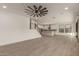 Open-concept living space with plank floors leading to the kitchen and staircase at 717 E Deer Creek Rd, Phoenix, AZ 85048