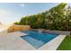 Sparkling pool with a waterfall, ample decking, and lush greenery, perfect for summer days at 717 E Deer Creek Rd, Phoenix, AZ 85048