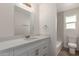 Brightly lit bathroom with white vanity, new fixtures, and tiled shower at 8014 N 55Th Ave, Glendale, AZ 85302