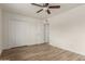 Bedroom with ceiling fan, closet and hardwood floors at 8014 N 55Th Ave, Glendale, AZ 85302