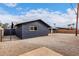 Exterior elevation of home with dark paint, block fence, and gravel yard at 8014 N 55Th Ave, Glendale, AZ 85302