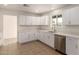 Bright kitchen showcases white cabinets, stainless steel appliances, and tile flooring at 8014 N 55Th Ave, Glendale, AZ 85302