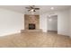 Bright living room featuring tile floors, a ceiling fan, a large brick fireplace, and recessed lighting at 8014 N 55Th Ave, Glendale, AZ 85302