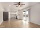 Open-concept living space, featuring tile floors and a sliding glass door, that connects the kitchen and dining area at 8014 N 55Th Ave, Glendale, AZ 85302