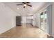 Open-concept living space, featuring tile floors and a sliding glass door, that connects the kitchen and dining area at 8014 N 55Th Ave, Glendale, AZ 85302