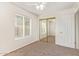 Bright bedroom featuring neutral walls, plush carpet, and a mirrored closet at 812 W Rosal Pl, Chandler, AZ 85225