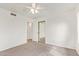 Carpeted bedroom featuring an open door, mirrored closet, and a ceiling fan at 812 W Rosal Pl, Chandler, AZ 85225