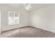 This bedroom features a carpeted floor, a window, and ceiling fan at 812 W Rosal Pl, Chandler, AZ 85225