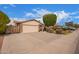 Suburban house with a spacious driveway, two-car garage, and manicured front yard with mature trees at 812 W Rosal Pl, Chandler, AZ 85225