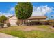 Attractive house with a well-kept lawn, mature trees, and a two-car garage for a suburban lifestyle at 812 W Rosal Pl, Chandler, AZ 85225