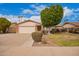 Charming single-story home featuring a two-car garage, well-maintained lawn, and mature shade trees at 812 W Rosal Pl, Chandler, AZ 85225