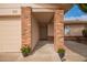 Inviting covered entry of a house with brick columns and decorative potted flowers at 812 W Rosal Pl, Chandler, AZ 85225