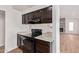 Kitchen view featuring wooden cabinets, speckled countertops, and black appliances at 812 W Rosal Pl, Chandler, AZ 85225