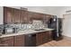 Kitchen with wooden cabinets, speckled countertops, and stylish backsplash at 812 W Rosal Pl, Chandler, AZ 85225