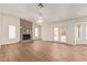 Open-concept living room with hardwood floors, a fireplace, and access to the backyard at 812 W Rosal Pl, Chandler, AZ 85225