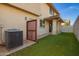 Cozy backyard featuring artificial grass, stucco wall, and a covered patio with beautiful arches at 919 S Pheasant Dr, Gilbert, AZ 85296