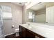 Bright bathroom features a single sink vanity with a white countertop and dark cabinets at 919 S Pheasant Dr, Gilbert, AZ 85296