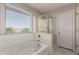 Bathroom featuring a soaking tub with shower, glass enclosure, and a bright window at 919 S Pheasant Dr, Gilbert, AZ 85296