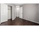 Bedroom featuring neutral walls, dark floors, closet, and entry door to the hallway at 919 S Pheasant Dr, Gilbert, AZ 85296