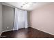 Comfortable bedroom with dark floors, a ceiling fan, and a bright window at 919 S Pheasant Dr, Gilbert, AZ 85296