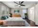 Bright main bedroom featuring hardwood floors, ensuite bathroom, white furniture, and a ceiling fan at 919 S Pheasant Dr, Gilbert, AZ 85296