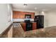 Updated kitchen features modern black appliances, dark brown wood cabinets, and a white subway tile backsplash at 919 S Pheasant Dr, Gilbert, AZ 85296