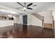 Spacious living room with dark wood floors, staircase, ceiling fan and open access to the kitchen at 919 S Pheasant Dr, Gilbert, AZ 85296