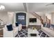 Bright living room featuring hardwood floors, white furniture, a blue accent wall, and staircase to the second floor at 919 S Pheasant Dr, Gilbert, AZ 85296