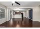 Open-concept living room with dark wood floors, an adjacent kitchen and access to outdoor patio at 919 S Pheasant Dr, Gilbert, AZ 85296