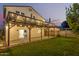 Expansive backyard featuring a covered patio strung with lights and a wooden deck above at 930 W Hudson Way, Gilbert, AZ 85233