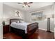 Bedroom with hardwood floors, a ceiling fan and a full bed with a giraffe art piece at 930 W Hudson Way, Gilbert, AZ 85233