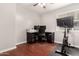 Cozy bedroom is currently utilized as a home office and workout space with cherry-wood laminate flooring at 930 W Hudson Way, Gilbert, AZ 85233