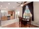 Dining area adjacent to the kitchen features modern lighting, access to the balcony, and a ceiling fan at 930 W Hudson Way, Gilbert, AZ 85233