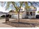 Charming two-story home with a tile roof, landscaped yard, and covered front porch at 930 W Hudson Way, Gilbert, AZ 85233