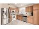 Clean kitchen featuring stainless steel appliances, light wood cabinets, and tile flooring at 930 W Hudson Way, Gilbert, AZ 85233