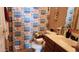 Cozy bathroom featuring a shower with a themed curtain, sink, and toilet at 9335 W Kingman St, Tolleson, AZ 85353