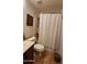 Small bathroom features a vanity, toilet, and shower with curtain at 9335 W Kingman St, Tolleson, AZ 85353