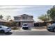 Charming two-story home with a well-maintained front yard and a two car garage and a newer vehicle at 9335 W Kingman St, Tolleson, AZ 85353