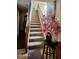 Carpeted staircase with wooden banister leads to the upper level of the home at 9335 W Kingman St, Tolleson, AZ 85353