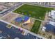 Aerial view showing a playground with a colorful sun shade, a basketball court, and green spaces in the community at 9918 E Tahoe Ave, Mesa, AZ 85212