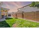 Landscaped backyard featuring lush grass, sturdy brick wall, and covered patio with seating at 9918 E Tahoe Ave, Mesa, AZ 85212