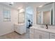 Elegant bathroom featuring dual vanities, framed mirrors, and a view of a workout space at 9918 E Tahoe Ave, Mesa, AZ 85212