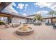 Inviting courtyard with a fountain, outdoor seating, and a modern building at 9918 E Tahoe Ave, Mesa, AZ 85212