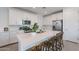 Beautiful kitchen featuring a large island with seating, stainless appliances, and crisp white cabinets at 9918 E Tahoe Ave, Mesa, AZ 85212