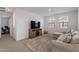 Upstairs Gathering room featuring plush carpet, entertainment center, and bright natural light at 9918 E Tahoe Ave, Mesa, AZ 85212