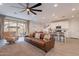 Inviting living room with an open floorplan to the kitchen and dining area for seamless living at 9918 E Tahoe Ave, Mesa, AZ 85212