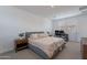 Cozy bedroom featuring a queen bed, two side tables, and bright light from the shuttered window at 9918 E Tahoe Ave, Mesa, AZ 85212