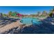 Community pool with a slide, lounge chairs and palm trees, perfect for relaxing and enjoying the outdoors at 9918 E Tahoe Ave, Mesa, AZ 85212