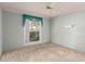 Carpeted bedroom featuring a large window at 9946 W Willow Creek Cir, Sun City, AZ 85373