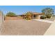 Single-story home showcasing a tidy yard, covered patio and extended driveway at 9946 W Willow Creek Cir, Sun City, AZ 85373